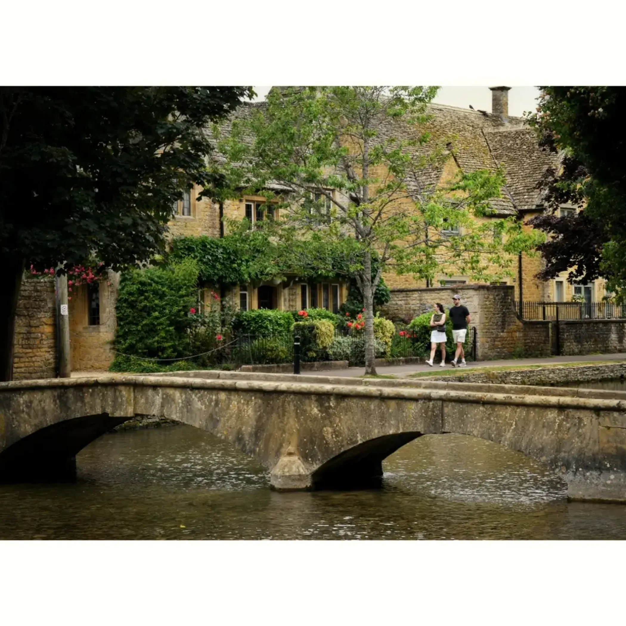 english green space with stone bridge